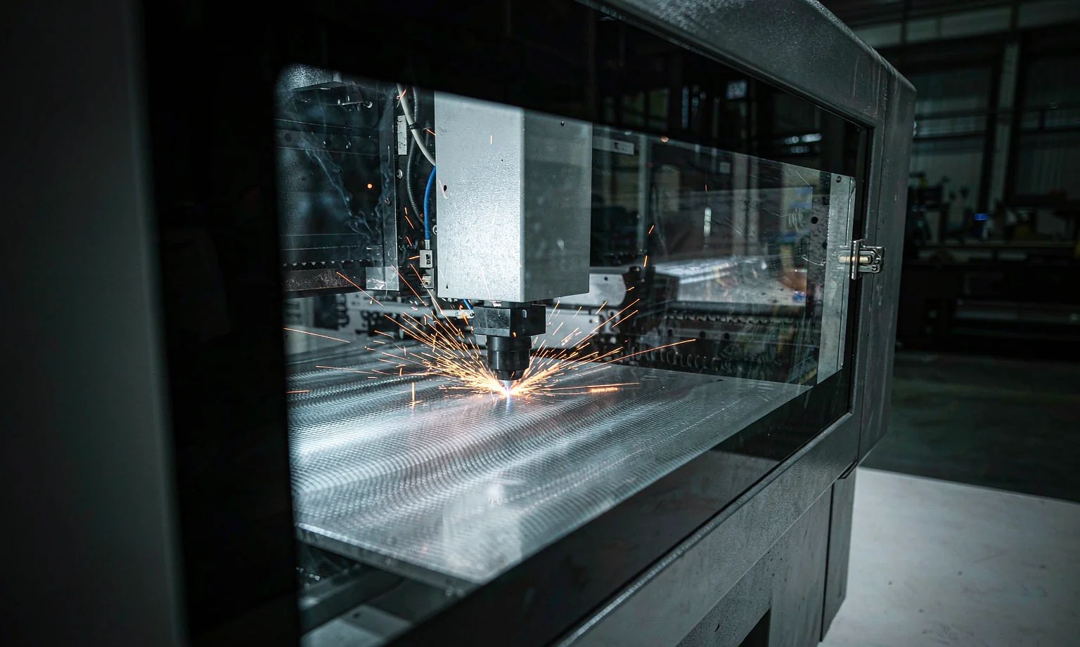 Fibre laser cutting steel sheet with bright sparks