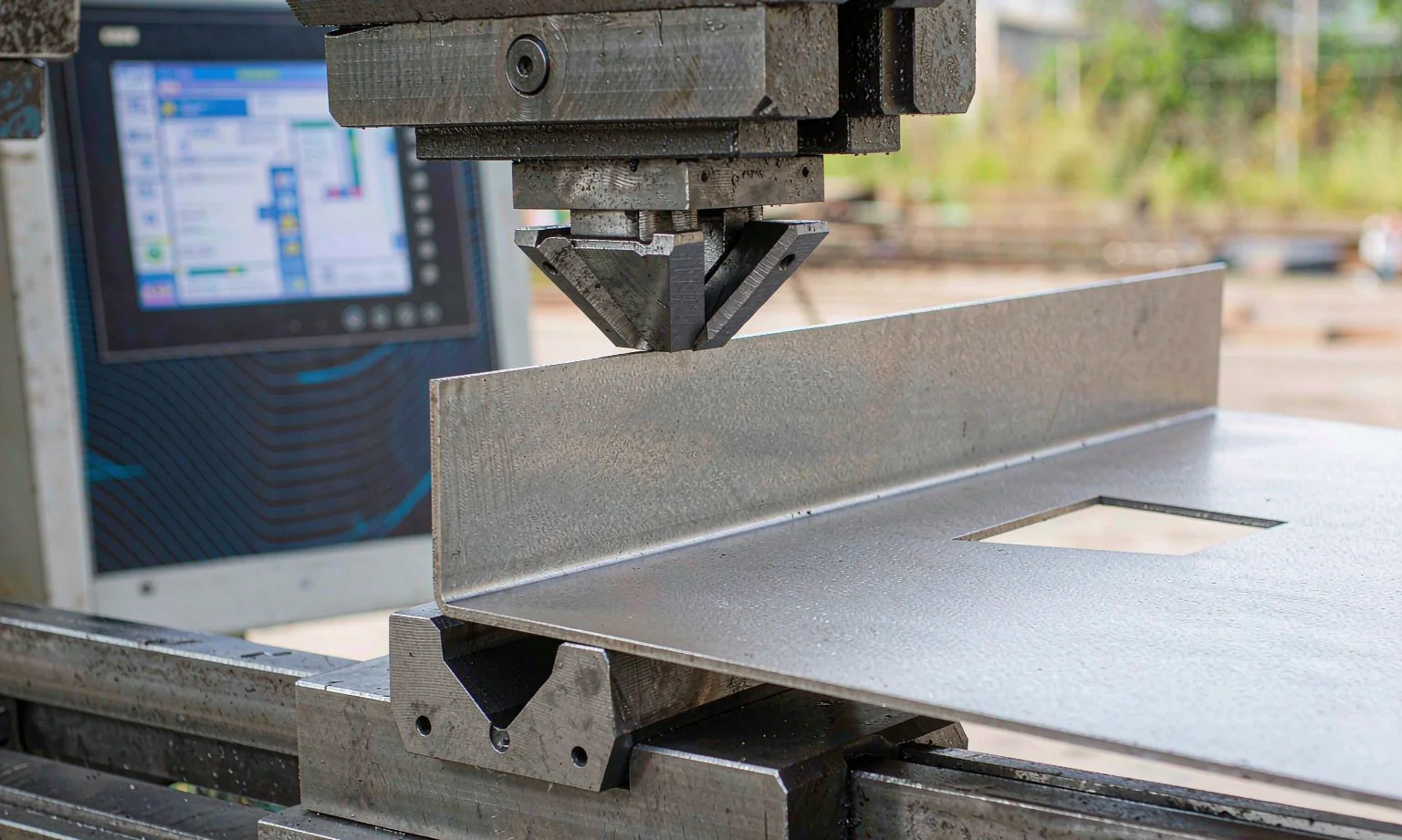 CNC press brake forming a steel panel