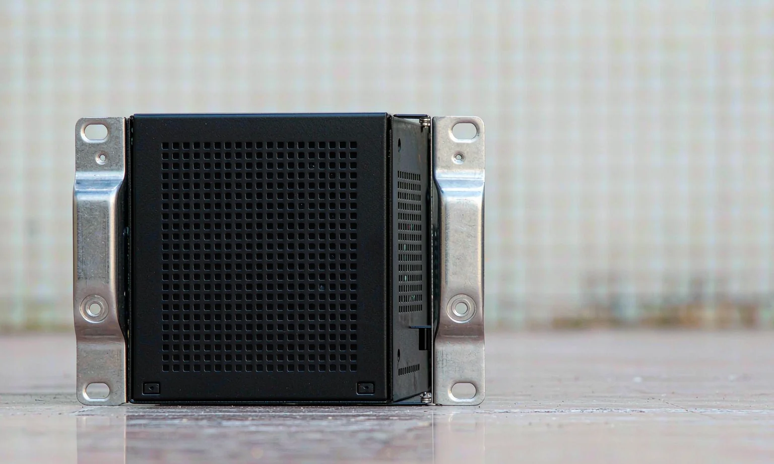 1U rack chassis front with punched ventilation slots and rack ears