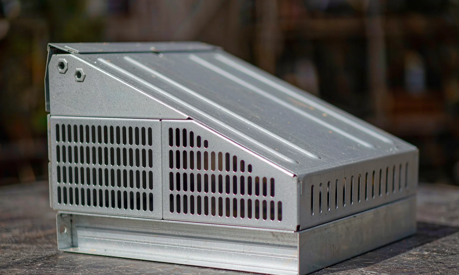 Formed metal chassis with louvre-punched ventilation panels