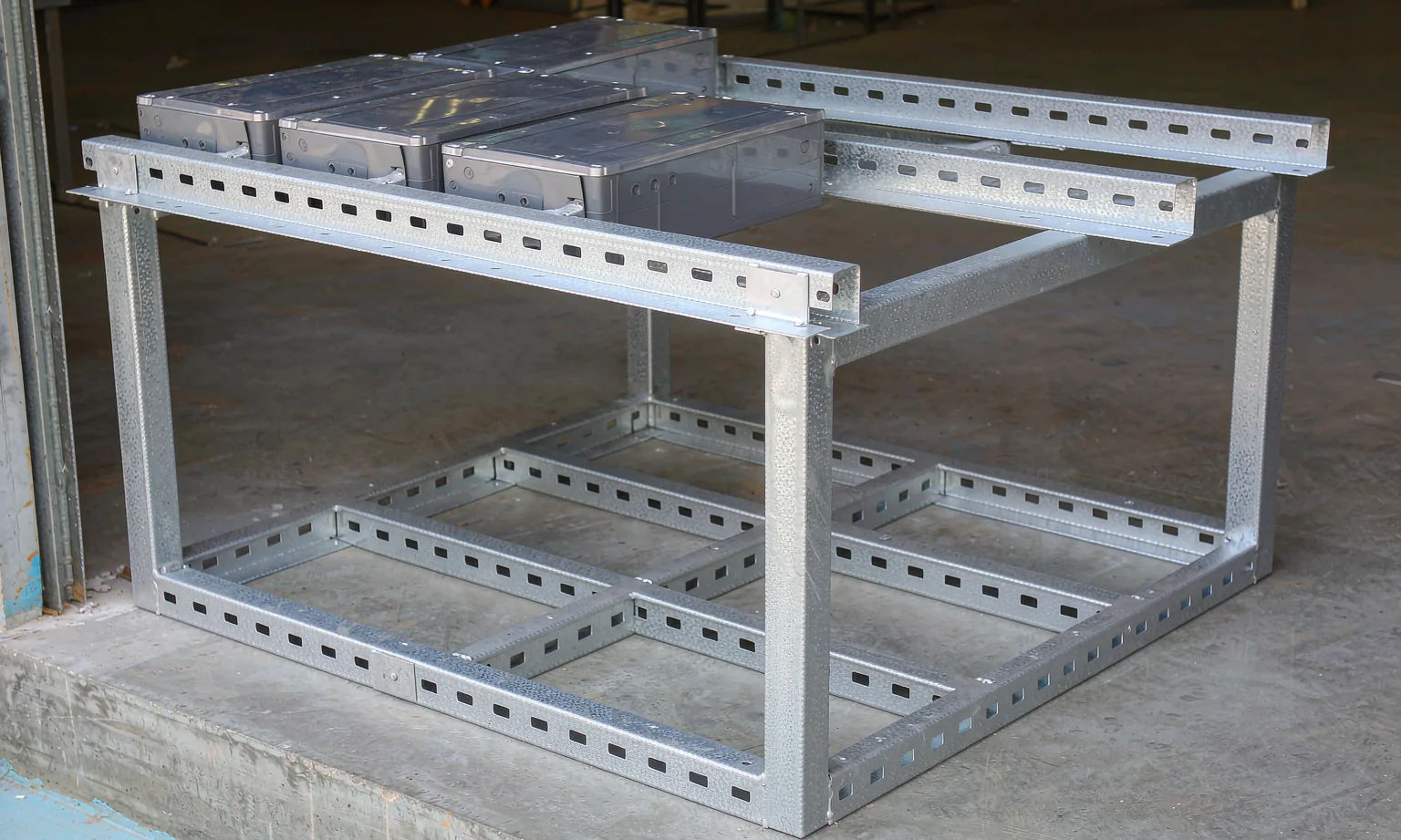 Galvanized steel battery module rack rails with mounting slots