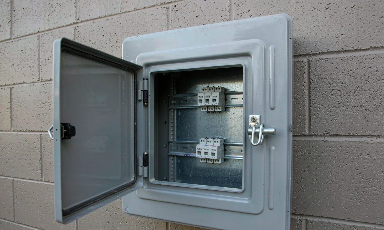 Distribution box open showing horizontal DIN rails