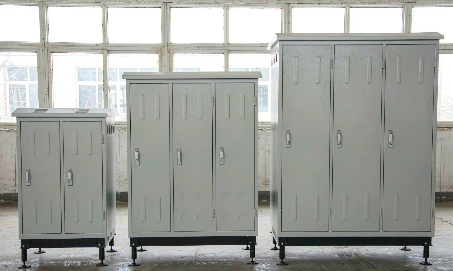 Electrical cabinets in three sizes with hinged doors and plinths
