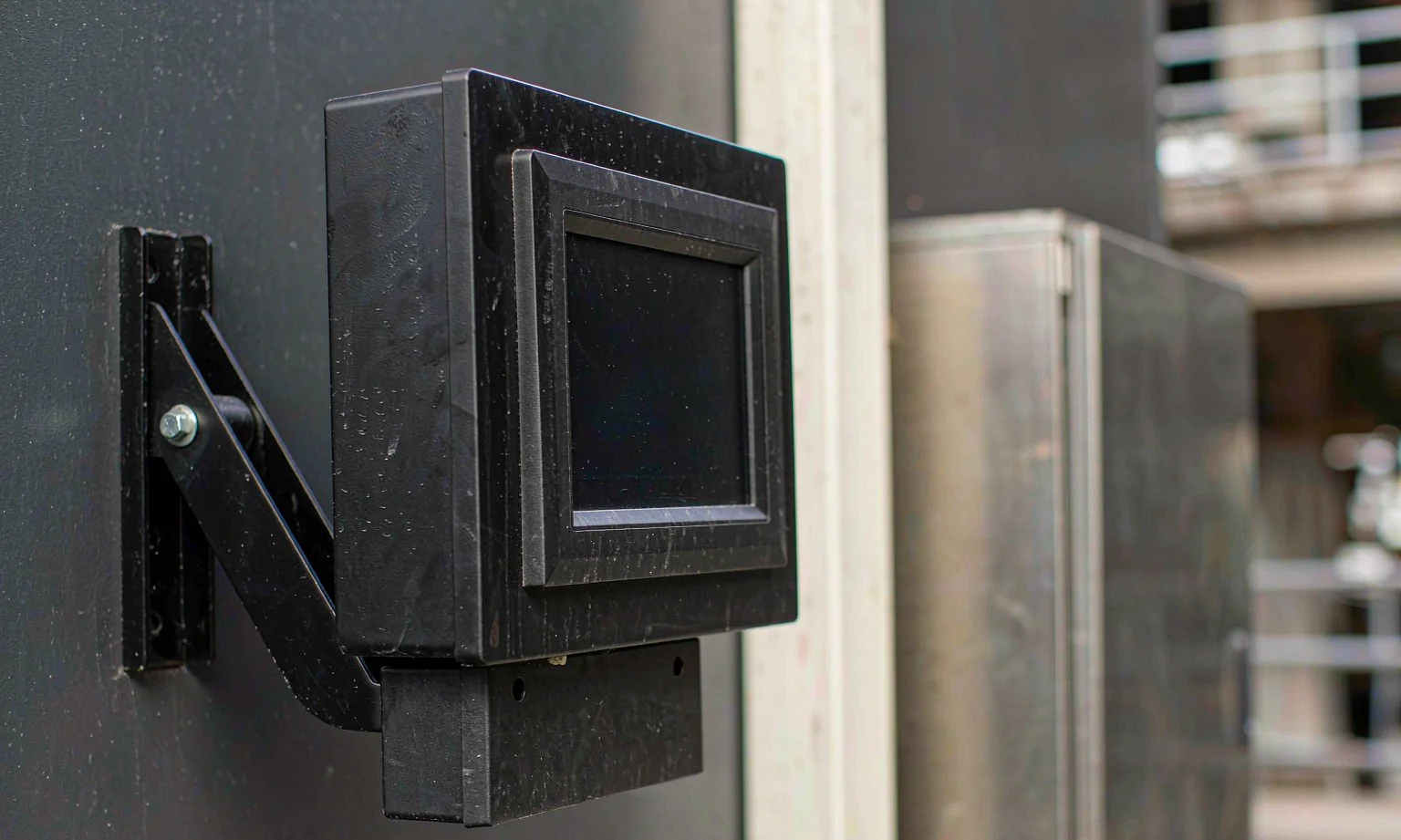 HMI operator panel enclosure mounted on an arm bracket