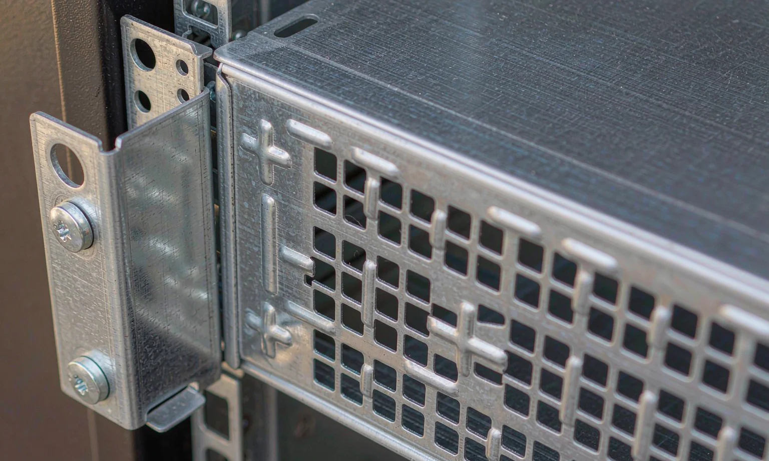 Rack chassis mounting ears with captive screw holes