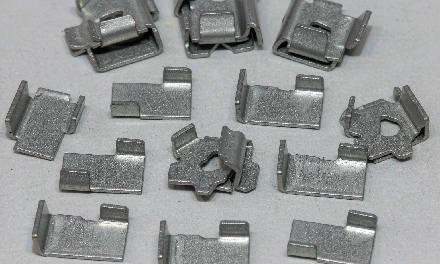 Small stamped sheet metal clips and formed tabs
