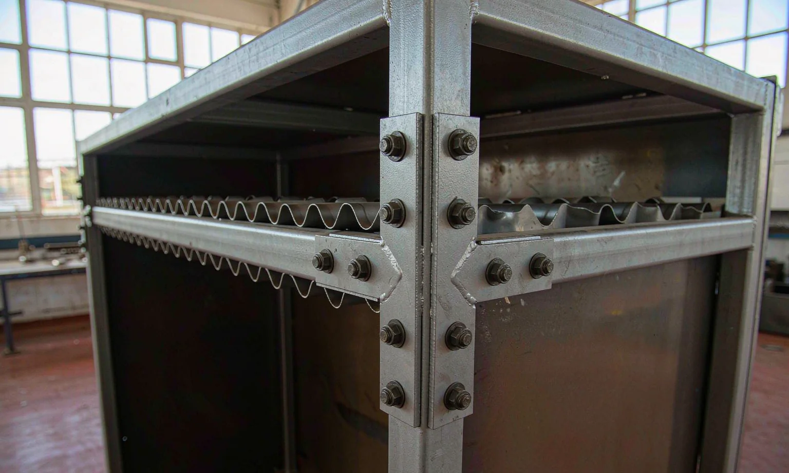Welded steel cabinet frame with bolted corner gussets